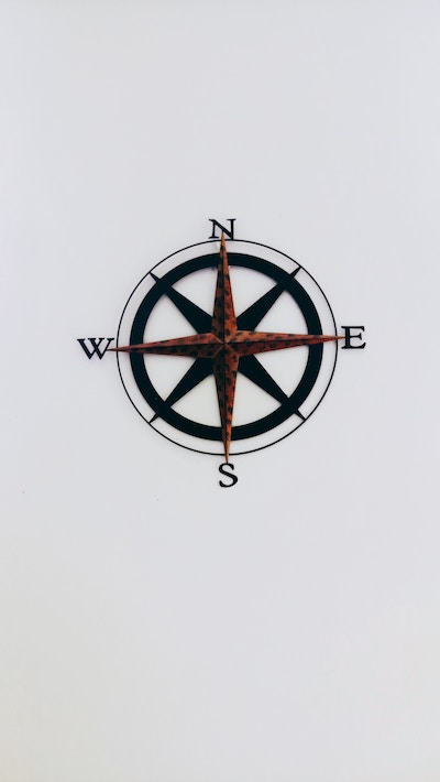 old fashioned compass rose on a plain wall